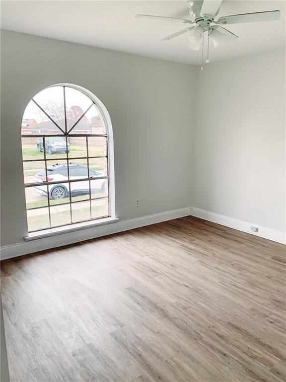 unfurnished room featuring ceiling fan and wood-type flooring