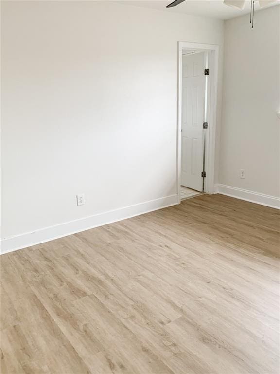 spare room featuring light wood-type flooring and ceiling fan