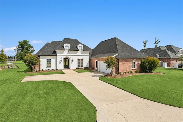 french provincial home with a garage and a front yard