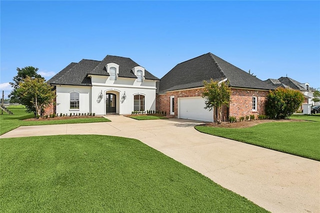 french country inspired facade featuring a garage and a front yard