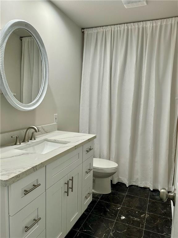 bathroom featuring vanity and toilet