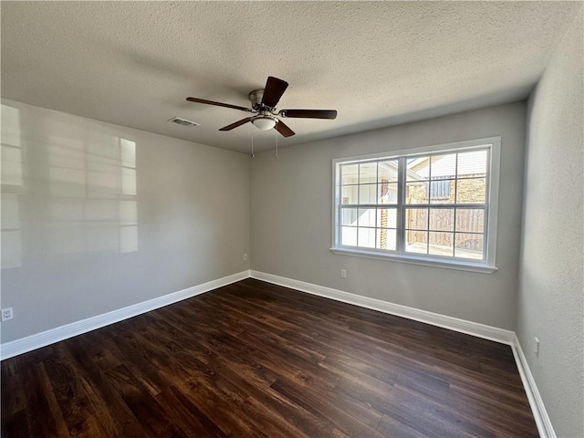 spare room featuring a textured ceiling, dark hardwood / wood-style flooring, and ceiling fan