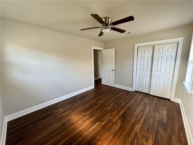 unfurnished bedroom featuring a closet, ceiling fan, and dark hardwood / wood-style floors