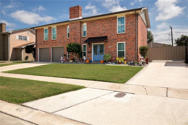 view of front of home featuring a front yard and a garage