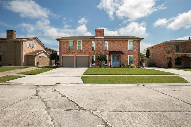 view of front of property with a garage and a front lawn