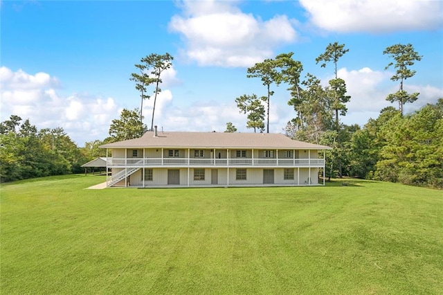 back of property with a lawn