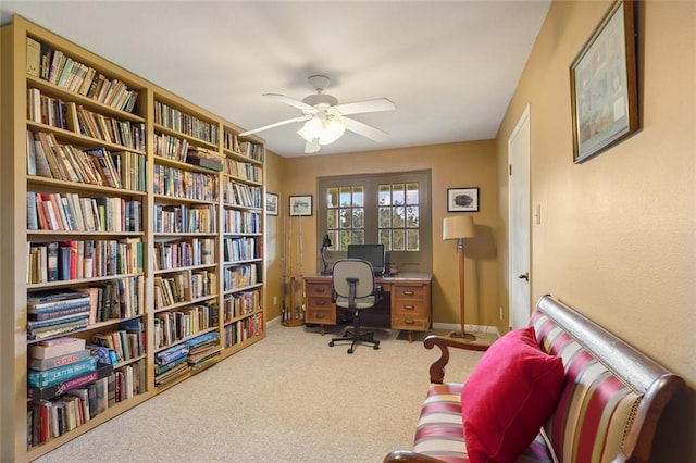 carpeted office with ceiling fan