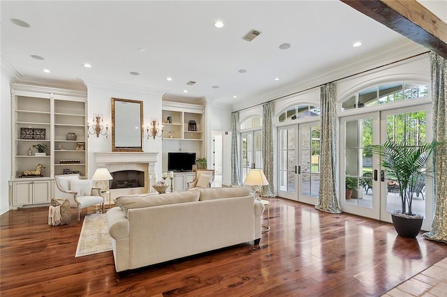 living room featuring ornamental molding, beam ceiling, dark hardwood / wood-style floors, and french doors