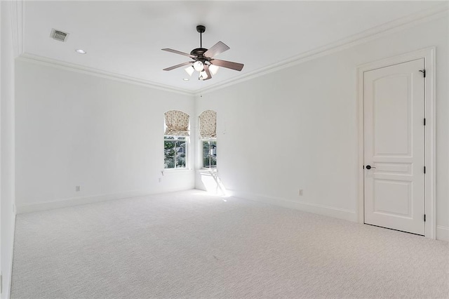 carpeted empty room with crown molding and ceiling fan