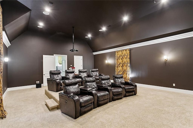 cinema with lofted ceiling and light colored carpet