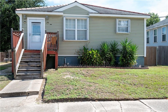 bungalow-style home featuring a front yard