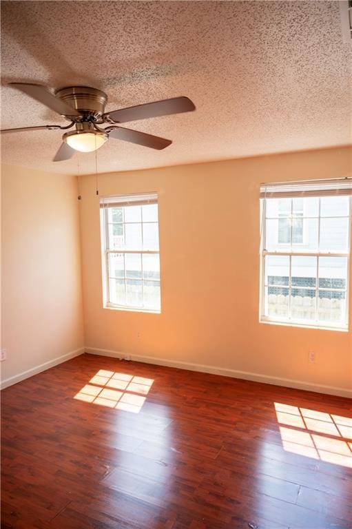 unfurnished room with a textured ceiling, dark hardwood / wood-style flooring, and ceiling fan