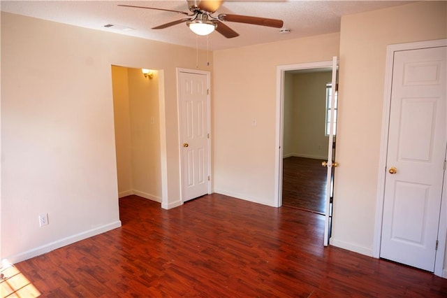 spare room with ceiling fan, dark hardwood / wood-style floors, and a textured ceiling