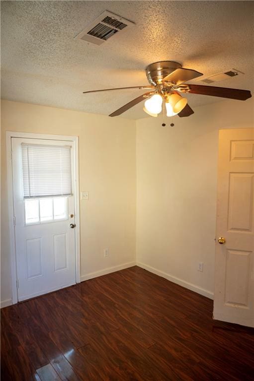 interior space with a textured ceiling, dark hardwood / wood-style flooring, and ceiling fan