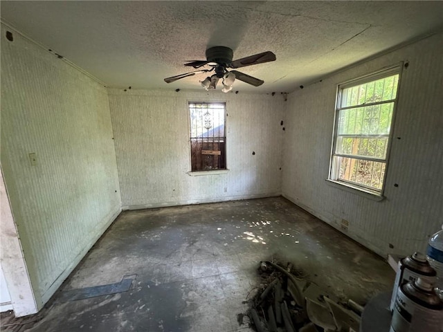 spare room featuring a textured ceiling and ceiling fan