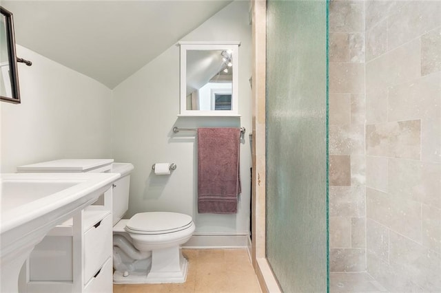 bathroom featuring a shower with shower door, vanity, lofted ceiling, toilet, and tile patterned floors