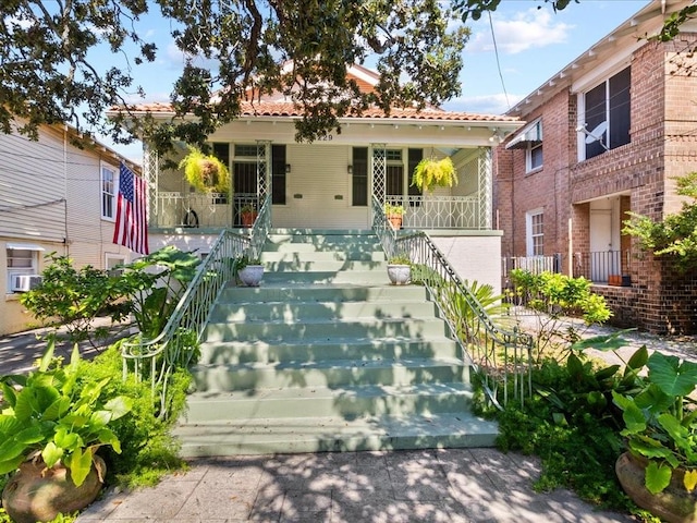 view of front facade featuring cooling unit and covered porch