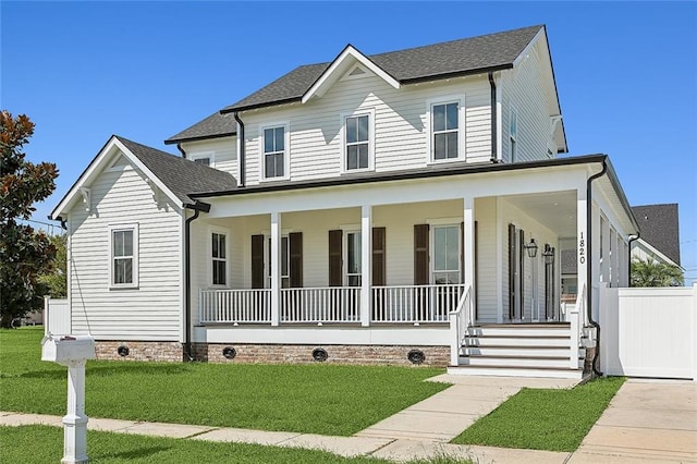 view of front of house with a porch and a front yard