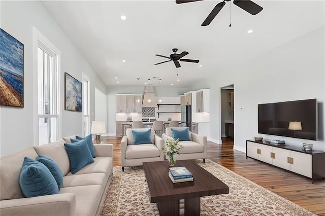 living room featuring a healthy amount of sunlight, hardwood / wood-style floors, and ceiling fan