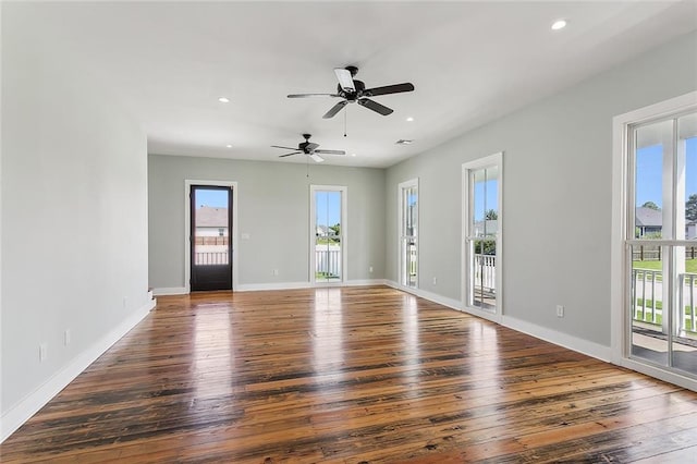 unfurnished room featuring ceiling fan and dark hardwood / wood-style floors