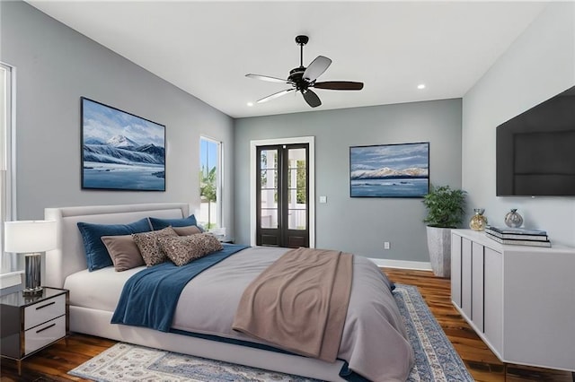 bedroom featuring access to exterior, french doors, dark hardwood / wood-style flooring, and ceiling fan