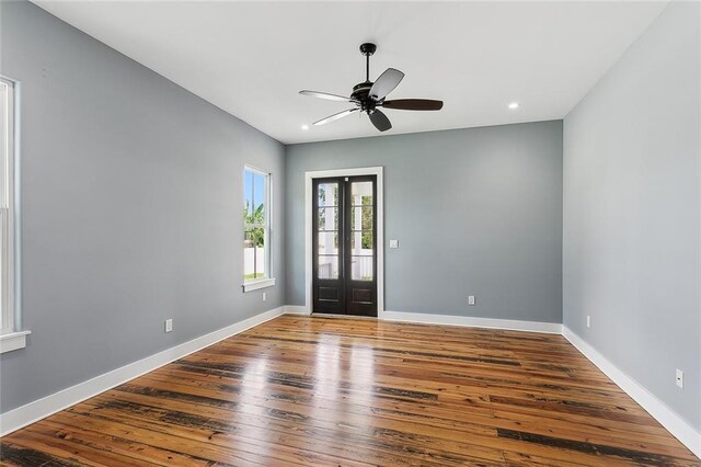 entryway featuring french doors, hardwood / wood-style floors, and ceiling fan