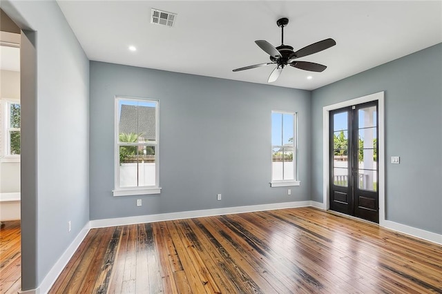 foyer featuring ceiling fan, wood-type flooring, a healthy amount of sunlight, and french doors