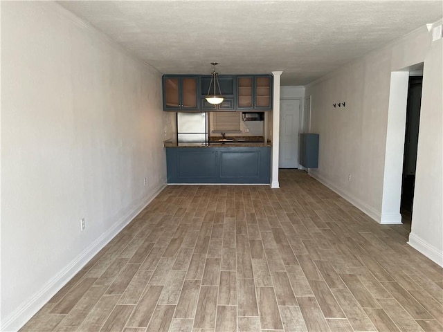 unfurnished living room with sink and light hardwood / wood-style flooring