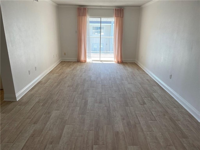 spare room featuring ornamental molding and dark wood-type flooring