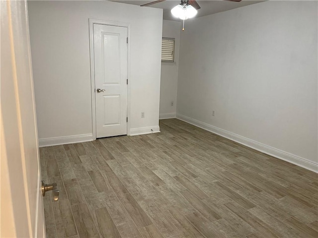 spare room featuring ceiling fan and light hardwood / wood-style flooring