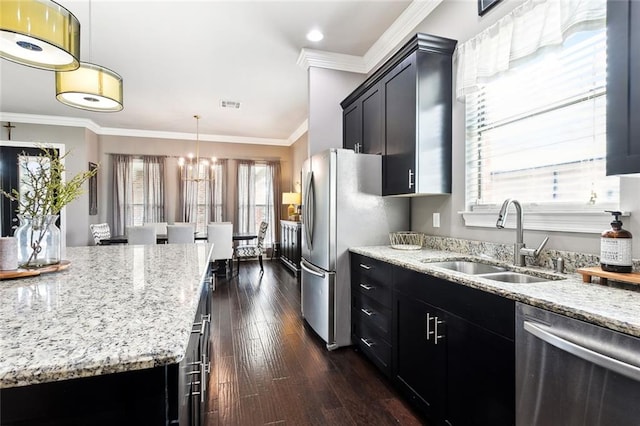 kitchen with a wealth of natural light, appliances with stainless steel finishes, dark hardwood / wood-style floors, and sink