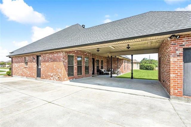 exterior space featuring a carport, a patio area, and a yard