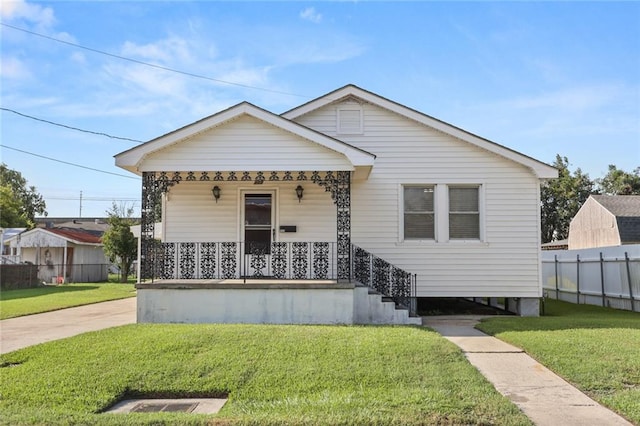 bungalow-style home with a front lawn and covered porch