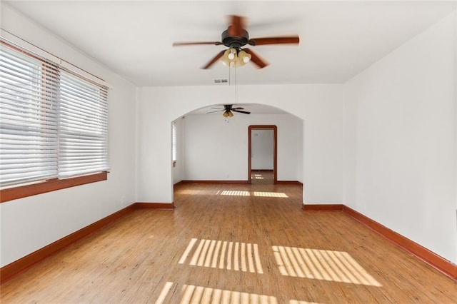 empty room featuring ceiling fan and light hardwood / wood-style flooring