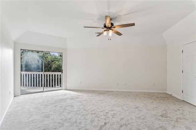 carpeted spare room featuring ceiling fan and vaulted ceiling