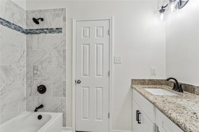 bathroom featuring vanity and tiled shower / bath combo