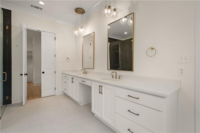 bathroom featuring ornamental molding, walk in shower, tile patterned flooring, and vanity