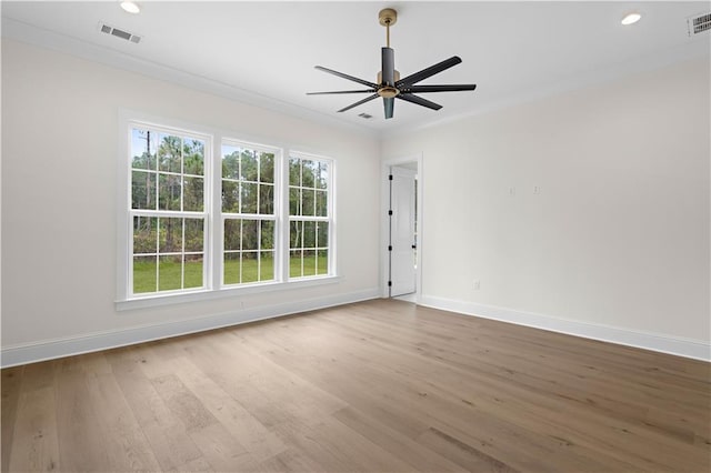 unfurnished room featuring wood-type flooring, ornamental molding, and ceiling fan