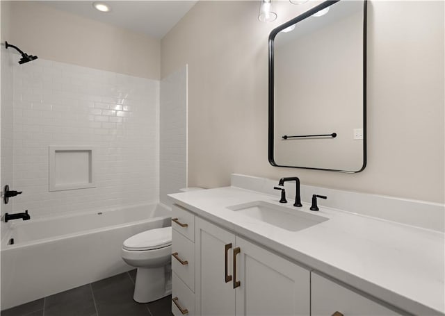 full bathroom with tiled shower / bath, tile patterned flooring, vanity, and toilet