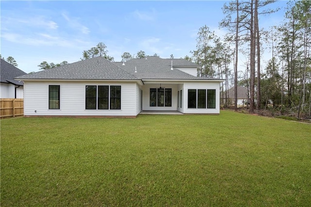 rear view of house featuring a lawn