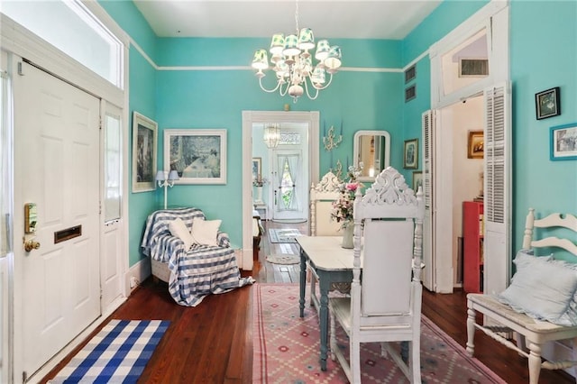 dining room with a notable chandelier and dark wood-type flooring