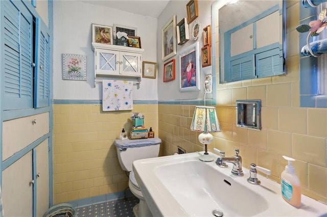 bathroom with tile walls, vanity, and toilet