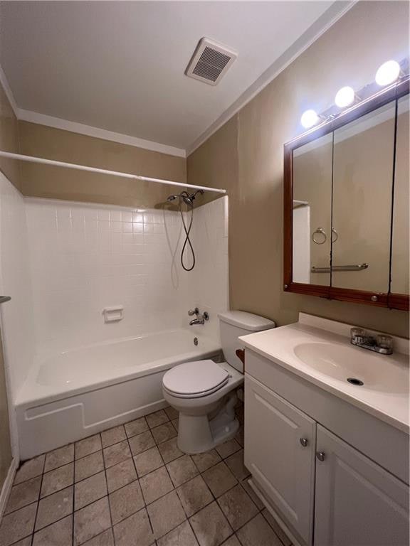 full bathroom with bathtub / shower combination, tile patterned flooring, crown molding, vanity, and toilet