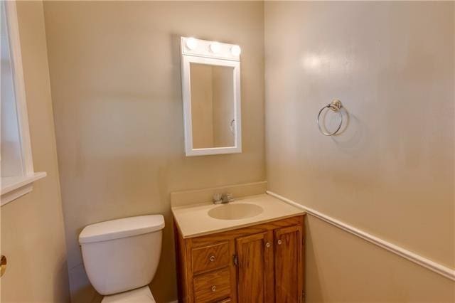 bathroom featuring vanity and toilet