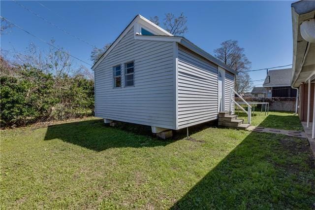 view of outbuilding featuring a yard