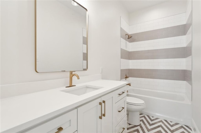 full bathroom with vanity, tiled shower / bath combo, toilet, and tile patterned floors