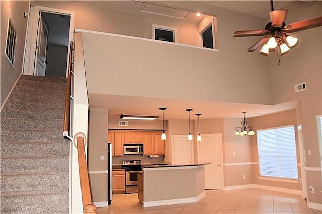 kitchen featuring dark countertops, baseboards, stainless steel appliances, and visible vents