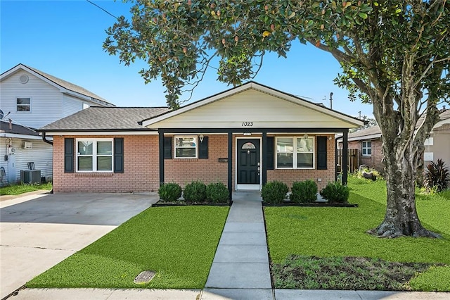 bungalow featuring central air condition unit, a front yard, and covered porch