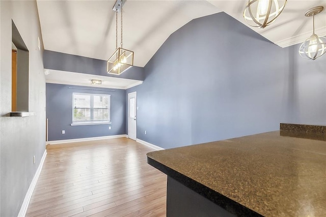 unfurnished dining area featuring lofted ceiling and hardwood / wood-style floors