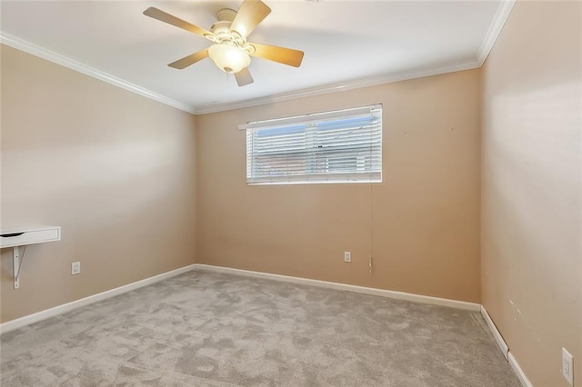 carpeted spare room with ceiling fan and ornamental molding